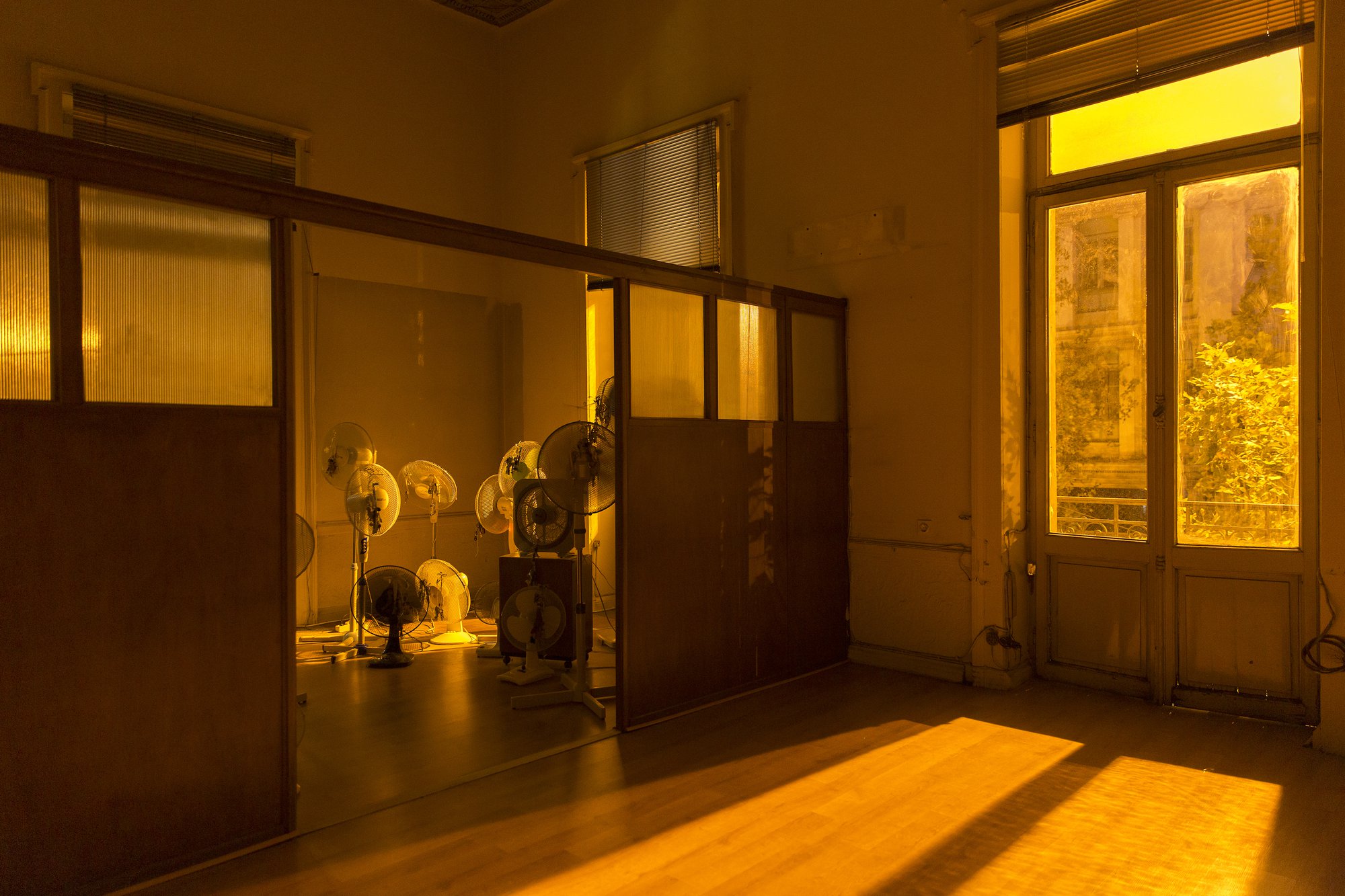 Iris Touliatou, Emotional Infinity (The sound of them coming back amplified and looped), fans, house keys, key chains, string, ribbons, gift bows, wire, timers, multiplugs, outlets, dimensions variable, 2021. Installation view, Eclipse, 7th Athens Biennial, Athens, 2021