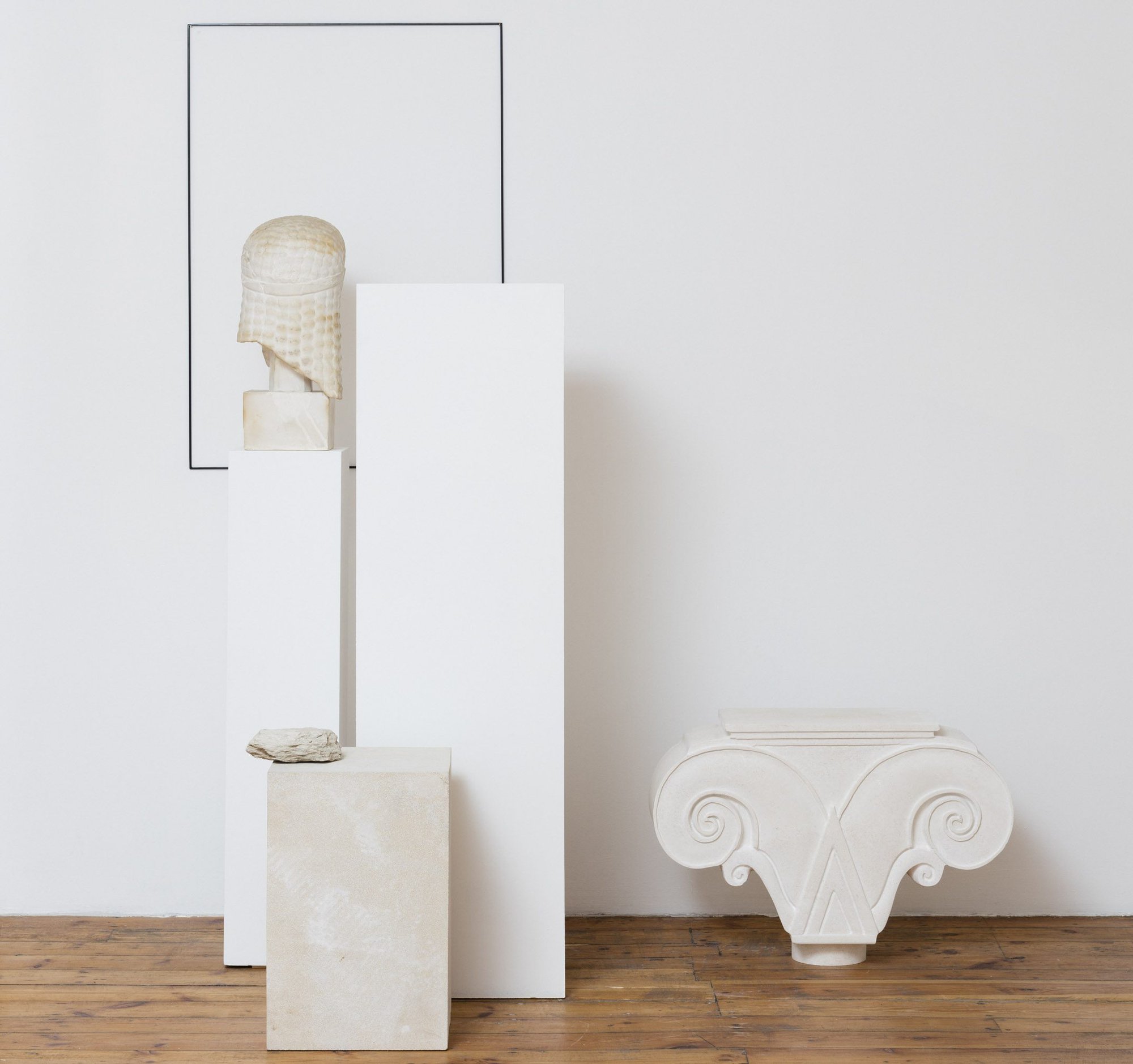 Haris Epaminonda, Untitled #05 a/w, detail, Kouros bust old museum replica in plaster, two wooden pedestals, white stone capitol, powder‐coated metal wall structure, limestone base, found stone, dimensions variable, 2016