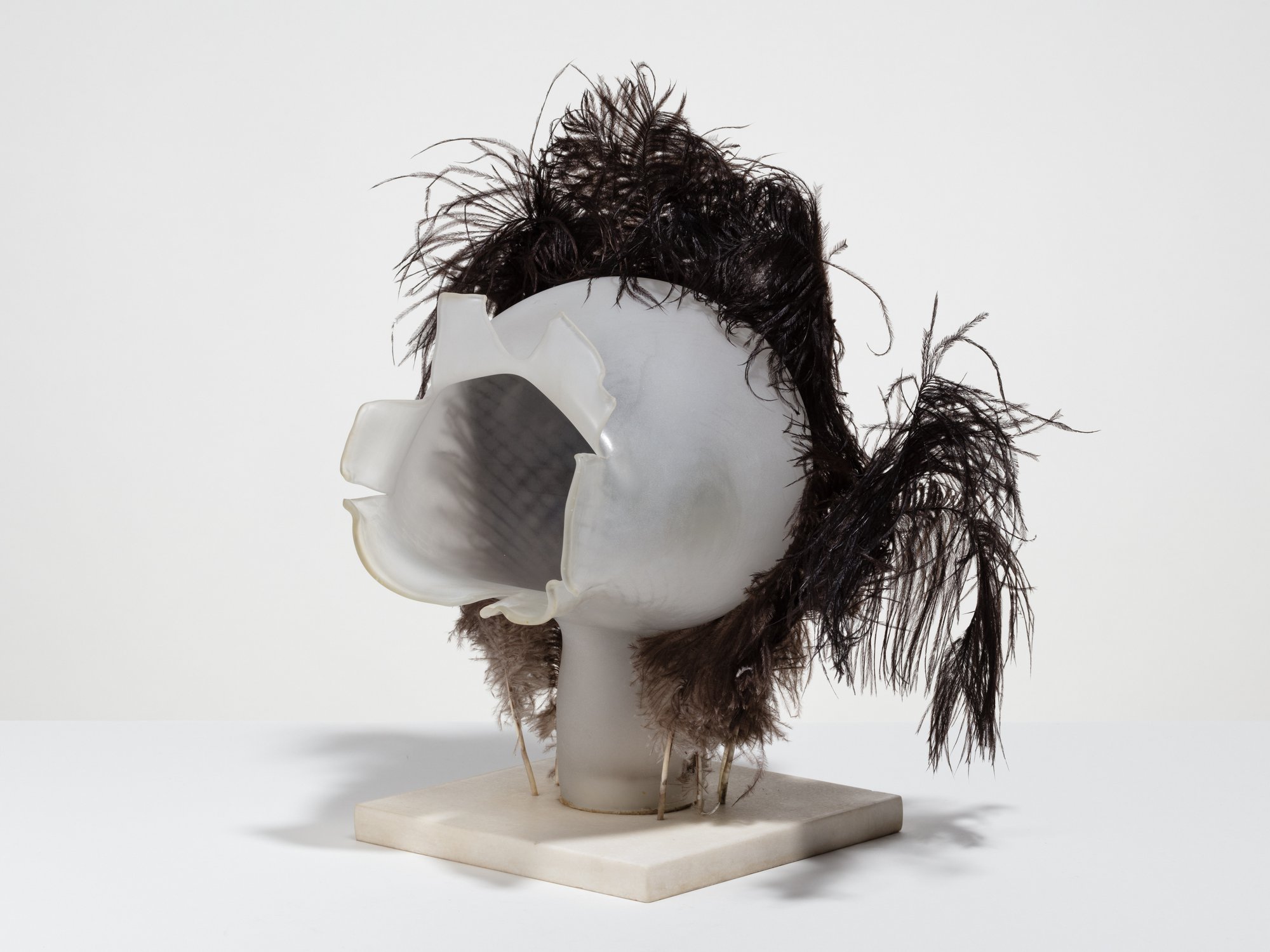 Liliane Lijn, Bridal Wound, sand blasted blown glass, ostrich feathers, white marble base, 38 x 35 x 27 cm (15 x 13 3/4 x 10 5/8 in), 1986 – 1990