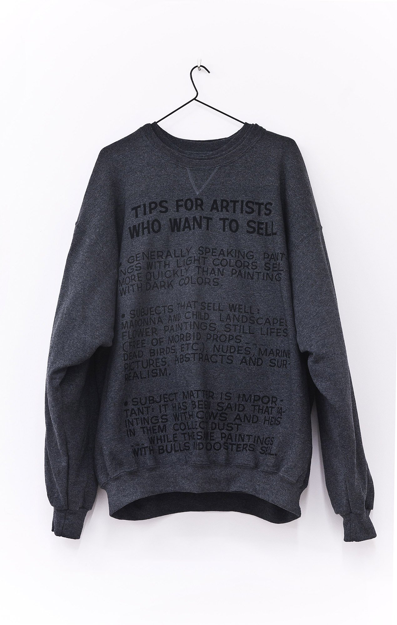 Banu Cennetoğlu, Baldessari for All, 4 sweatshirts printed in Istanbul with a text by John Baldessari. The sweatshirt imitates the original reproduction that was done for Baldessari’s retrospective at MOCA. In M, L, XL, XXL, 2010. Installation view, SAMPLE SALE / 2010 BC, Rodeo, Istanbul, 2010
