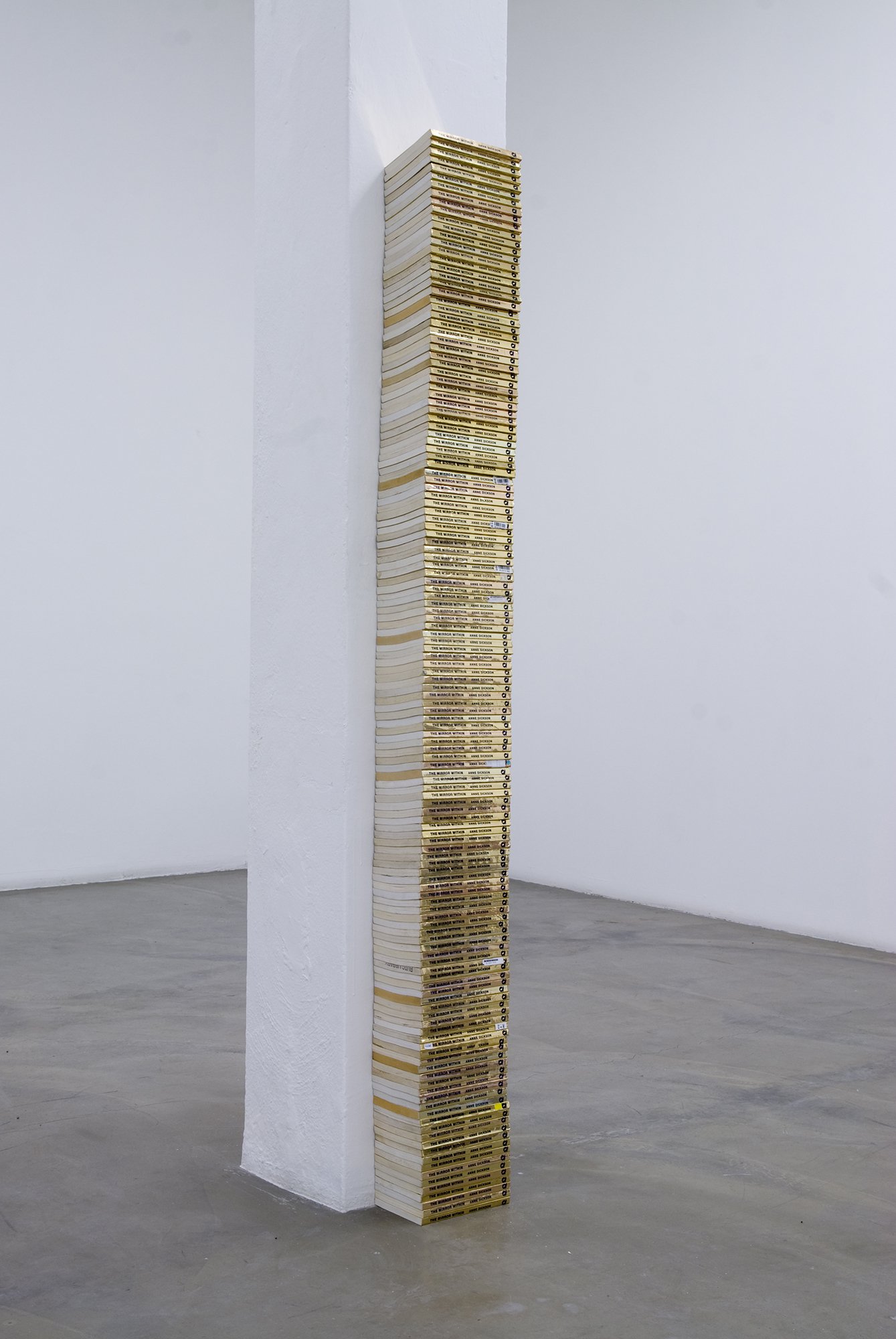 James Richards, Untitled (The Mirror Within), stacked second hand books, 180 x 19,5 × 13 cm (70 7/8 x 7 5/8 x 5 1/8 in), 2010 – 2011. Installation view, James Richards, Rodeo, Istanbul, 2011