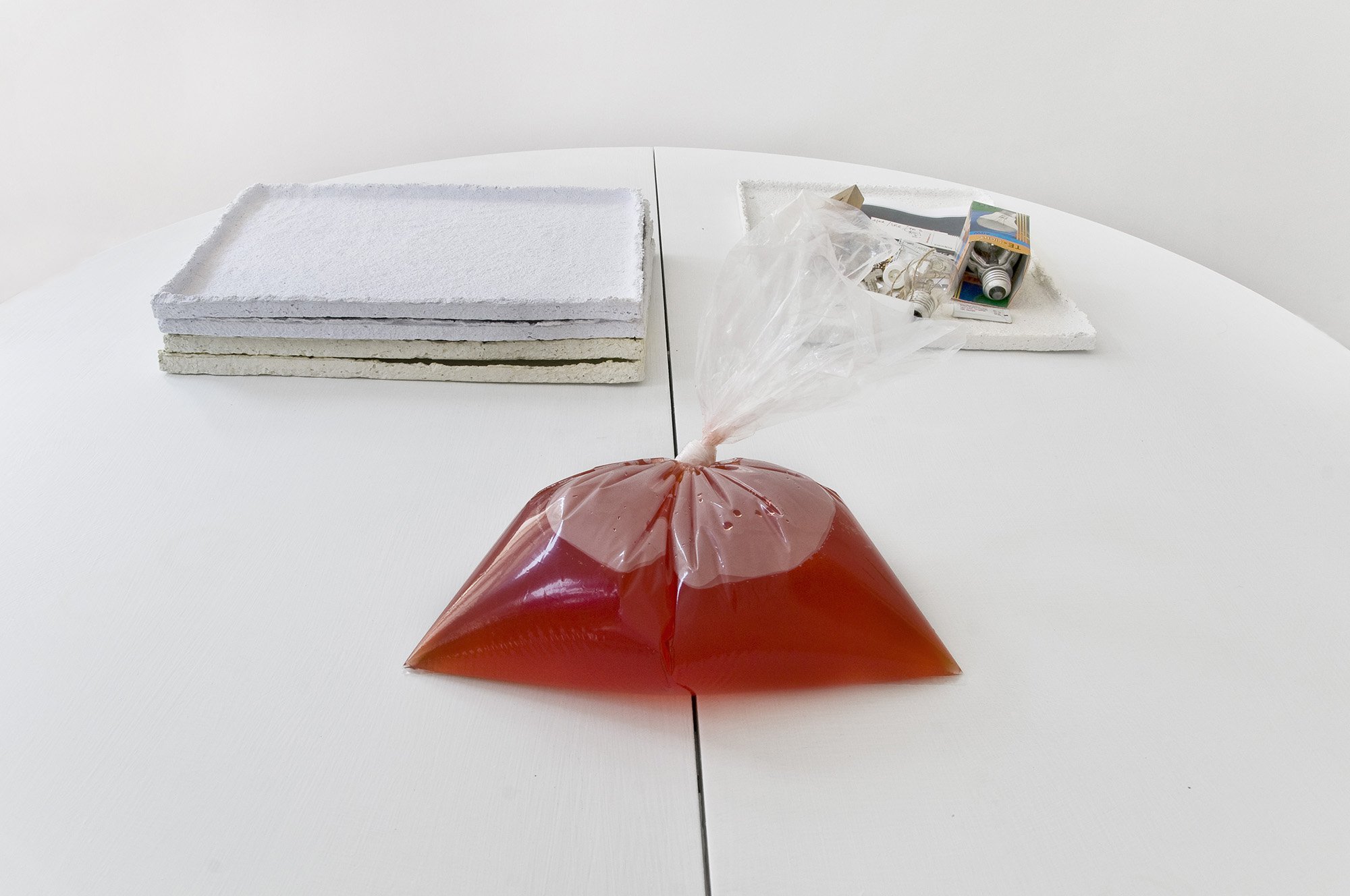 Ian Law, run off, residual water, paper dye, baking powder, adhesive in plastic bag, 2012