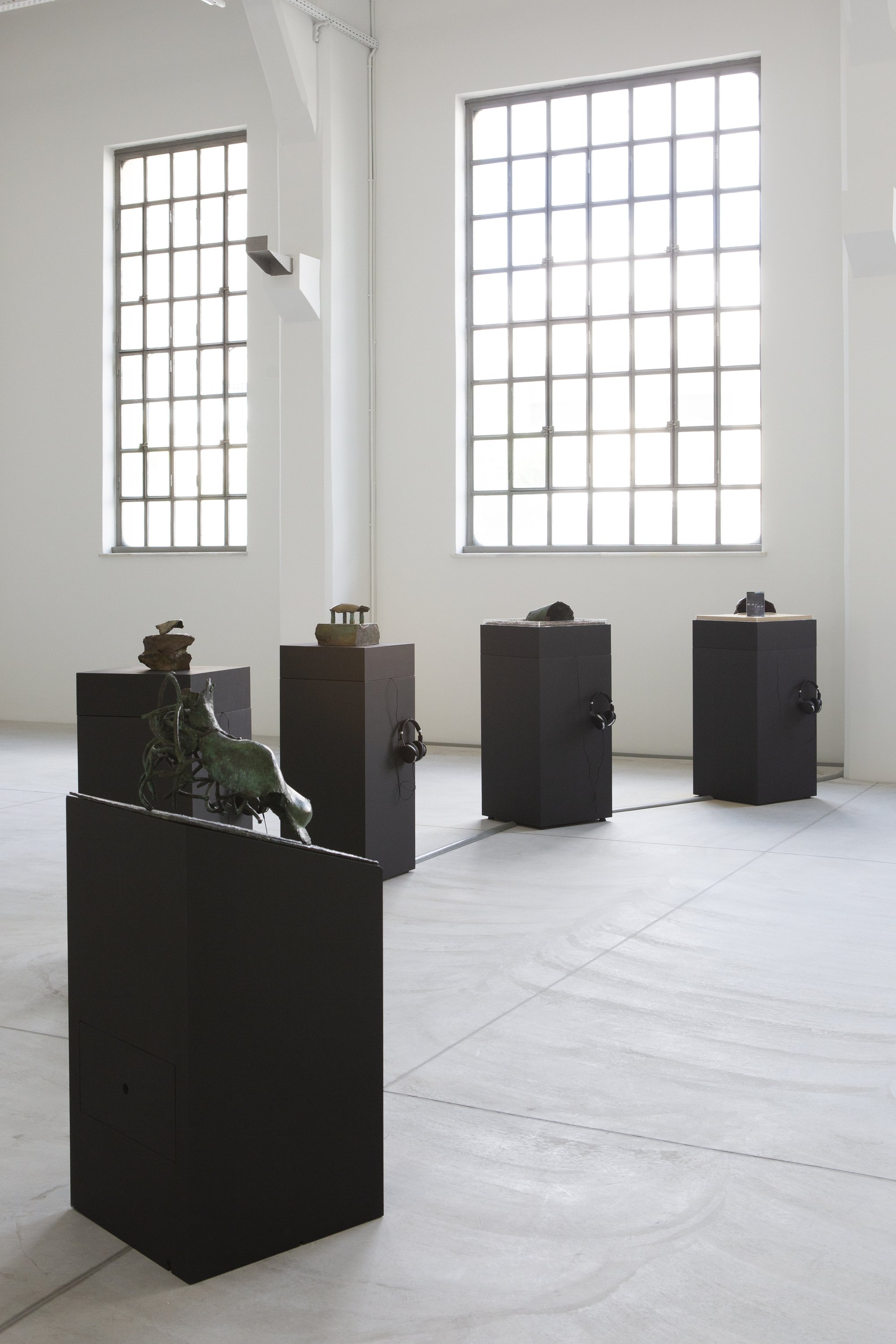 Liliane Lijn, Early Events, Five sculptures, patinated bronze, freestanding painted MDF bases and media players, dimensions variable, 1996-2000. Installation view, Portals, NEON, Former Tobacco Factory, 2021