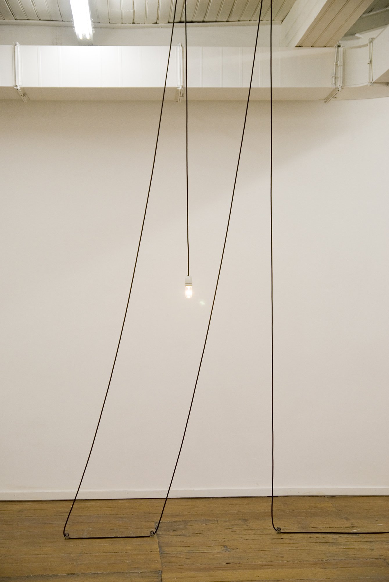 Giles Round, From wine jugs to lighting fittings; M, black braded electrical flex, lamp and pulleys, 2008. Installation view, Children of the Revolution, Rodeo, Istanbul, 2008
