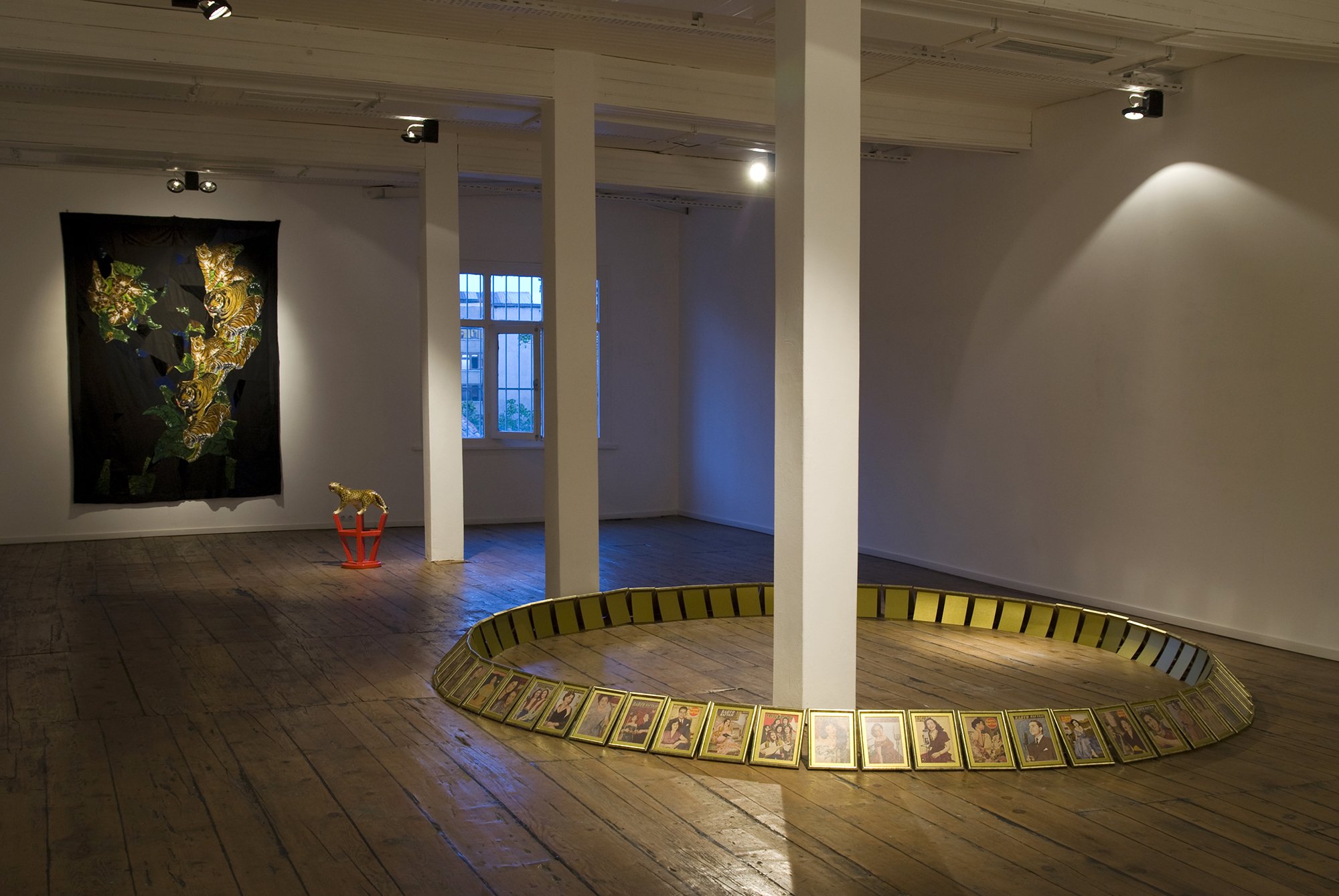 (On floor) Gülsün Karamustafa, Chronographia, 60 pieces of 21 x 30 cm (8 1/4 x 11 3/4 in) coloured prints, diameter 3.05 m (120 1/8 in). Installation view, Opening, Rodeo, Istanbul, 2009
